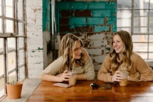 Two people talking at a cafe